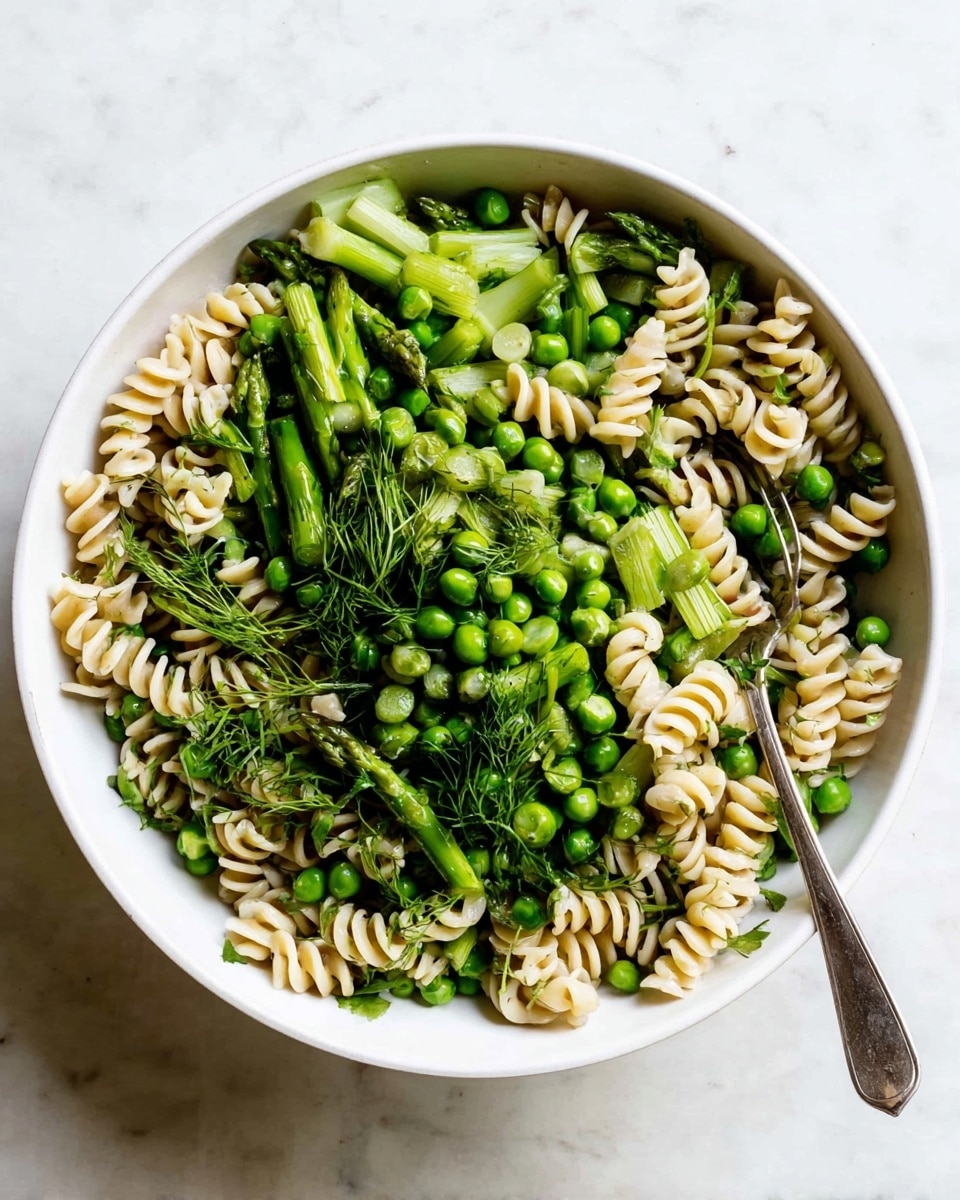 The image shows small round pastries with a soft golden-brown crust, each having a hollow center filled with creamy white cheese and topped with bright red raspberries and a glossy raspberry sauce. One pastry in the front has a bite taken out of it, revealing a soft, fluffy inside with the layers of crust, cream, and fruit clearly visible. The pastries are dusted lightly with powdered sugar and set on white marbled textured paper with a few whole raspberries scattered around. The photo taken with an iphone --ar 4:5 --v 7