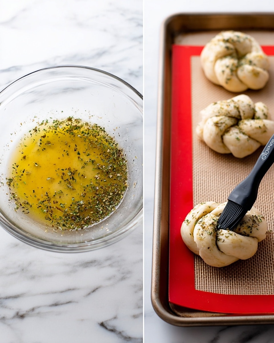 The image shows two parts: on the left, a clear glass bowl with a light yellow oil mixture sprinkled with green and black herbs, sitting on a white marbled surface; on the right, three light tan dough knots arranged on a baking tray topped with a red silicone mat, a black brush applying the same herb mixture onto one dough knot, all set on the white marbled background. photo taken with an iphone --ar 4:5 --v 7