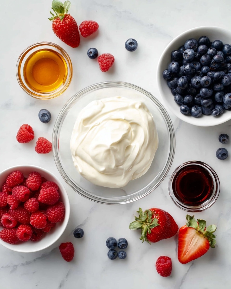 A clear glass bowl in the center holds a smooth, creamy white yogurt or whipped cream with soft peaks. Around it, on a white marbled surface, are smaller white bowls with fresh fruits: one filled with dark blue blueberries, another with bright red raspberries. Small glass bowls beside these contain amber-colored honey and dark brown vanilla extract. Scattered around are ripe strawberries with green tops and a few loose blueberries and raspberries adding more color and texture. The arrangement is bright, fresh, and clean. Photo taken with an iphone --ar 4:5 --v 7